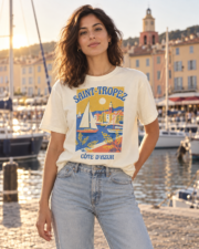 Woman in the ivory Saint-Tropez Côte d'Azur tee standing by the old port of Saint-Tropez at golden hour