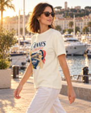 Woman walking by Cannes marina in the ivory Cannes Côte d’Azur Comfort Colors 1717 tee