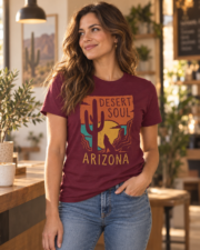 Woman wearing the Arizona Desert Soul t-shirt in maroon in a warm desert-inspired café