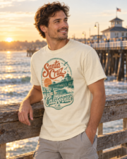 Man in a three-quarter view wearing an ivory Santa Cruz California surf T-shirt