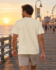 Back view of a man wearing a blank ivory Comfort Colors 1717 T-shirt on the Santa Cruz pier