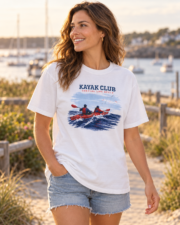 Woman wearing the white Kayak Club coastal T-shirt on a beach path.
