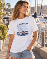Woman wearing the white Yacht Club coastal T-shirt in a three-quarter view at a marina.