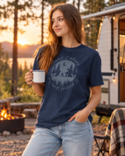 Woman holding a camping mug wearing the True Navy dog graphic tee, three-quarter view