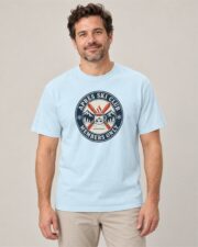 Man wearing the Chambray Après Ski Club Crest T-shirt, front view, studio