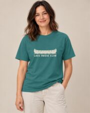 Woman wearing the Emerald Lake House Club Canoe T-shirt, front view, studio