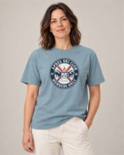 Woman wearing the Ice Blue Après Ski Club Crest T-shirt, front view, studio
