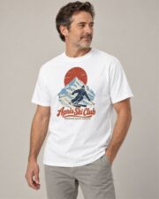 Man wearing the White Après Ski Club Skier T-shirt, three-quarter view, studio