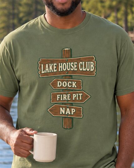Man wearing the Moss Lake House Club Signpost T-shirt with a coffee mug by the lake, close-up