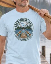 Man carrying canoe paddles in the Chambray Lake House Club Crest T-shirt, close-up of the crest
