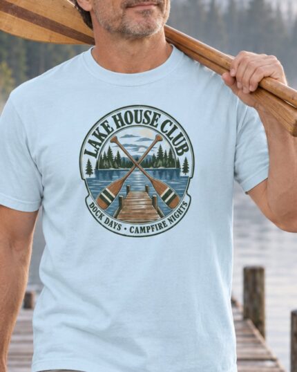 Man carrying canoe paddles in the Chambray Lake House Club Crest T-shirt, close-up of the crest