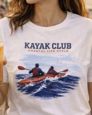 Woman wearing the Kayak Club coastal T-shirt in white.