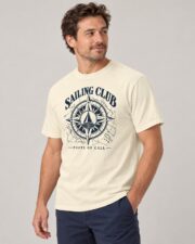 Man wearing the Ivory Sailing Club Compass Rose T-shirt, three-quarter view, studio