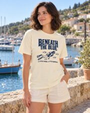 Woman wearing the Ivory Beneath the Blue scuba diver T-shirt near the harbor
