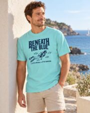 Man in the Lagoon Blue Beneath the Blue T-shirt standing by the sea