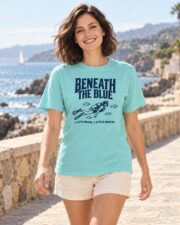 Woman wearing the Lagoon Blue Beneath the Blue T-shirt on a coastal walkway