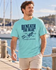 Man in the Lagoon Blue Beneath the Blue scuba diver T-shirt on a seaside promenade